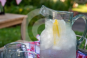 Pitcher of cold lemon water in the backyard