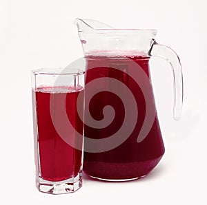 Pitcher and glass of red fruit juice isolated