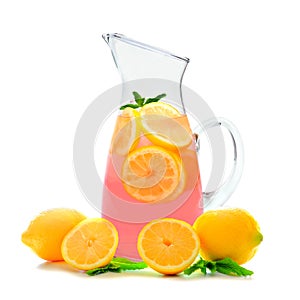 Pitcher of pink lemonade with mint isolated on white