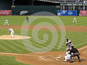 Pitcher throws pitch to batter with ball in air