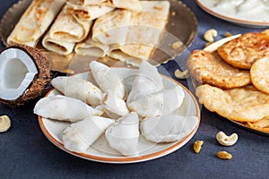 Pitha Pulli is a traditional Bengali dish, featuring rice flour dumplings filled with jaggery, coconut, and sometimes khoya.
