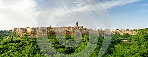 Pitigliano town, located atop a volcanic tufa ridge, known as the little Jerusalem, surrounded by lush valleys carved by the Lente photo