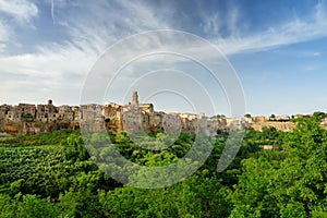 Pitigliano town, located atop a volcanic tufa ridge, known as the little Jerusalem, surrounded by lush valleys carved by the Lente photo