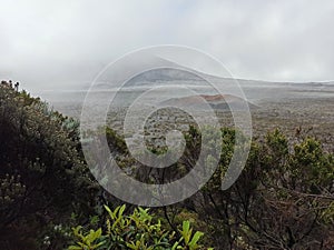 Piton de la Fournaise, Enclos fouque aerial view in hostile weather with clouds and fog, Reunion photo