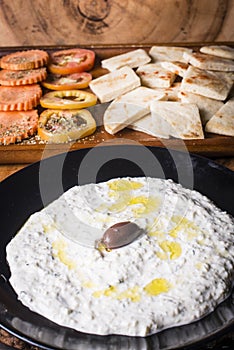 Pitta bread served with a bowel of tzatziki