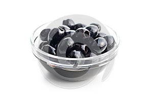Pitted black olives in bowl isolated on white background