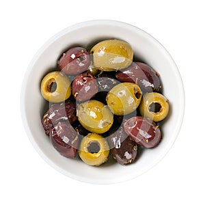 Pitted Kalamata and green olives, mixed olives with herbs in a white bowl photo