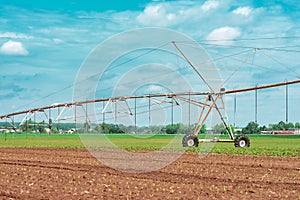 Pivot irrigation system in cultivated soybean and corn field