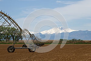 Pivot Irrigation System in a farming field with Longs Peak Mount