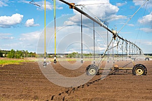 A pivot sprinkler system on wheels for potato field.