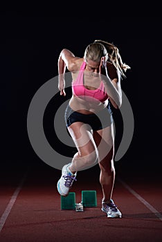 Pixelated design of woman sprinter leaving starting blocks