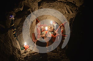 Pixie gang eating a Christmas meal in an underground den, only with light from the candles