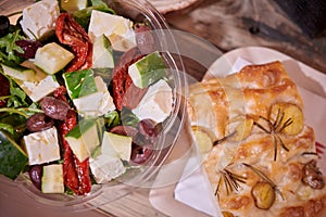 Pizza with baby potatoes and Rosemarie and fresh arugula salad with tomatoes, olives, cucumbers and feta cheese