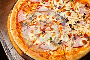 Pizza with bacon and cheese on a dark background. Close-up, selective focus