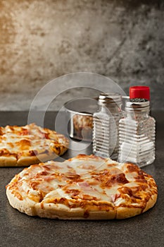 Pizza bacon Ham with a hot dog and cheese Mockup seasonings are salts, oregano, and paprika, front view and copy space for text