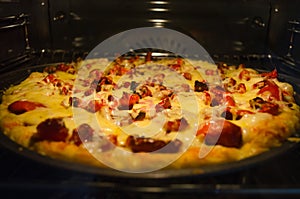 Pizza baking in oven