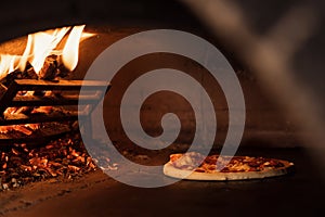 Pizza Baking in a Traditional Wood-Fired Oven