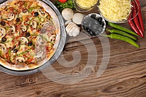 Pizza baking, wood background, ingredients, copy space