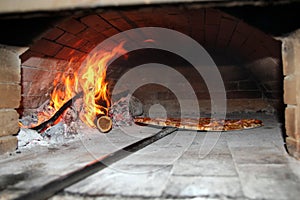 Pizza Baking in Wood Fired Oven photo