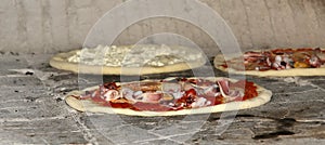 Pizza being baked in a wood fire brick oven in a restaurant