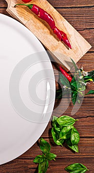 Pizza board with a napkin on white wooden table. Top view vertical mock up. A round white plate on a wooden table with a