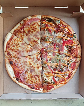 pizza in box with half and half topping