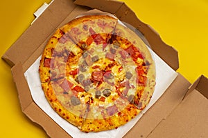 A pizza in a box with topping