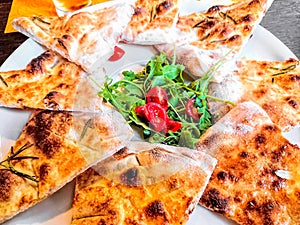 Pizza bread with arugula and tomatoes italian style