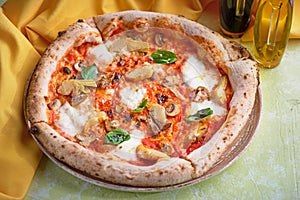 Pizza carciofo. Vegetarian pizza with Mozzarella, artichokes, mushrooms, basil. photo