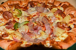 Pizza in a cardboard box against a wood background. Pizza menu. Food ingredients and spices for cooking mushrooms, tomatoes, chee