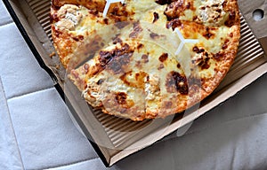 Pizza in a cardboard box isolated on white background.