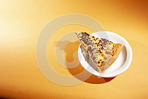 Pizza with cheese and chocolate sprinkles. Isolated on orange lighting background with portrait photography.