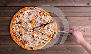 Pizza with cheese and pizza paddle