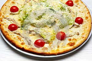 Pizza with chicken, cheese, herbs and tomatoes