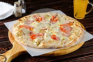 Pizza with chicken and tomatoes rustic style