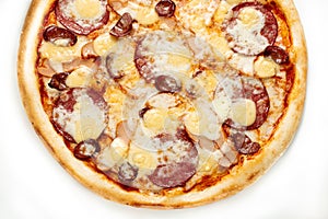 Pizza Close Up with salami, sausage and cheese isolated on white background. Copyspace. Top view