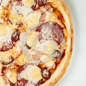 Pizza Close Up with salami, sausage and cheese isolated on white background. Copyspace. Top view