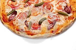 Pizza Close Up with sausage, ham, onion, Pickled gherkins and cheese isolated on white background. Copyspace. Top view