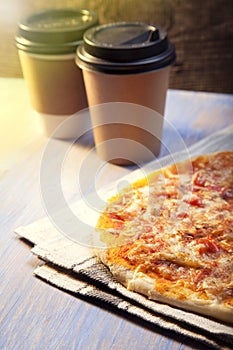 Pizza and Coffee on wooden table, cup of cappuccino.