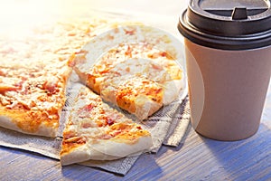 Pizza and Coffee on wooden table, cup of cappuccino.