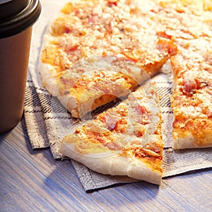 Pizza and Coffee on wooden table, cup of cappuccino.