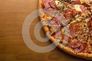 Pizza, composition: sauce, mozzarella cheese, pepperoni sausage, ham, bacon