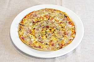 Pizza cooked with carbonara recipe with pieces of smoked bacon, oregano,