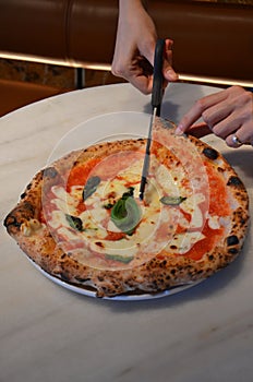 Pizza cut into slices from a 400 degree pizza oven, Italian style