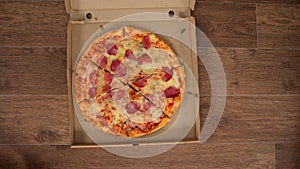 Pizza delivery in a box and parsing it in pieces with hands, stop motion animation