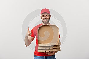 Pizza delivery concept. Young boy is delivering and showing pizza boxs in boxes. Isolated on white background