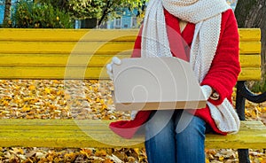 Pizza delivery holding take away box yellow red woman park autumn