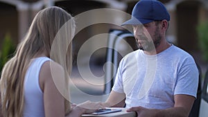 Pizza delivery man giving boxes to female client