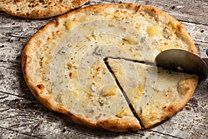 Pizza with different toppings. Italian pizza with different sorts of cheese, vegetables and meat on old wooden background close up