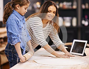 Pizza, dough and child with mother in kitchen and tablet for recipe, guide and learning from online tutorial. Cooking